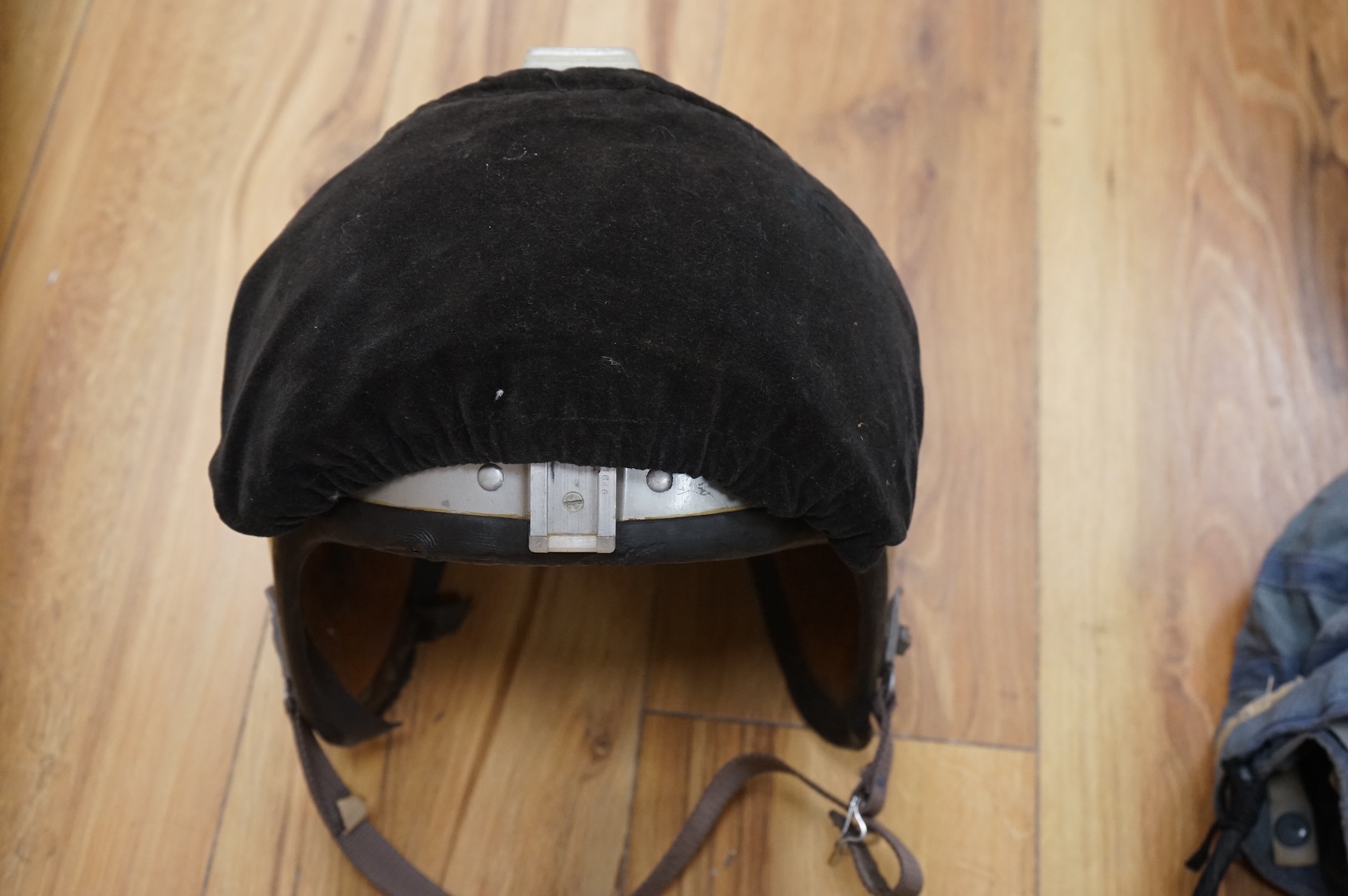 An early British jet aircraft RAF flying helmet, size 3 regular, dated 1958, with visor and visor cover, and original interior webbing, complete with inner cloth flight cap with built-in headphones and electrics and date